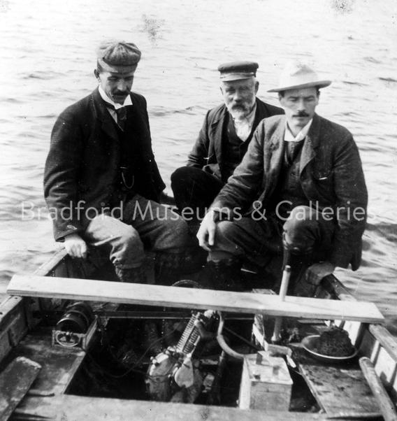 Alfred and (Angus?) Scott in motorcycle engine powered boat